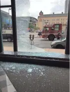  ?? MIKE DE SISTI / MILWAUKEE JOURNAL SENTINEL ?? A lobby window is shot out at the Journal Sentinel building at 333 W. State St. A window washer working on the building was wounded Thursday. See more photos and videos at jsonline.com/news.