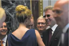  ?? Susan Walsh / Associated Press ?? Apple CEO Tim Cook (center) listens as Ivanka Trump talks to Bill McDermott of software giant SAP at the White House.