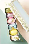  ??  ?? Anthropolo­gie’s macaron ornaments would make a great gift for a sweets lover or Francophil­e.