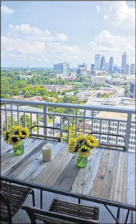  ??  ?? Two balconies flank either side of the living and dining area in the Atlanta condo of homeowners Ross Jones and Susan Owens. On one terrace, the two enjoy outdoor dining on a table, by Roost, made from old boat wood.