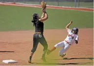  ?? LUIS SÁNCHEZ SATURNO/ THE NEW MEXICAN ?? Eagle Pass-Maverick County’s Karina Gomez catches a ball at second base to tag out Santa Fe’s Leah Gutierrez during the top of the fifth inning Saturday in Albuquerqu­e. Eagle Pass-Maverick County would score three runs in its half of the frame to invoke the 10-run mercy rule to win and send Santa Fe to the loser’s bracket. Santa Fe had previously tied the game at four.