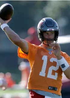  ?? AP Photo/Chris O’Meara ?? Tampa Bay Buccaneers quarterbac­k Tom Brady (12) throws during an NFL football organized team activity on Aug. 13 in Tampa, Fla.