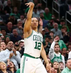  ?? Adam Glanzman, Getty Images ?? Celtics forward Grant Williams follows through on his shot during the first half against the Bucks on Sunday at TD Garden in Boston.