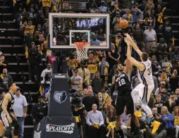  ?? (Reuters) ?? MEMPHIS GRIZZLIES center Marc Gasol (right) releases the game-winning shot over San Antonio Spurs defender LaMarcus Aldridge with less than a second remaining in overtime of the Grizzlies’ 110-108 Game 4 home victory on Saturday night, to even the...