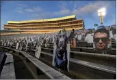  ?? BARRY REEGER — THE ASSOCIATED PRESS FILE ?? Cardboard cutouts of fans sit in the south stands before an Oct. 31 college football game between Penn State and Ohio State in State College, Pa.