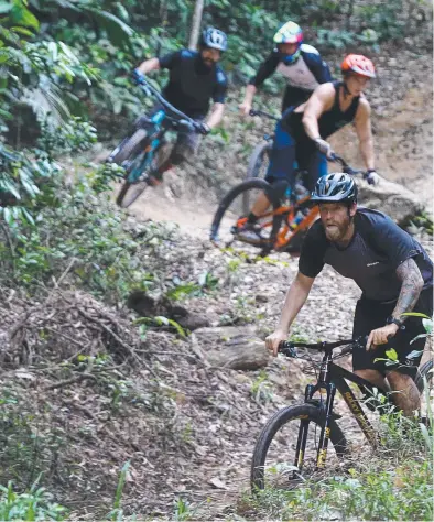  ?? THRILL: Cairns Mountain Bike Club president Craig Nissen leads members Steph Garner, ??