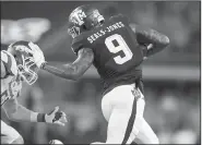  ?? NWA Democrat-Gazette/JASON IVESTER ?? Texas A&M wide receiver Ricky Seals-Jones (9) pushes away a tackle attempt by Arkansas linebacker Brooks Ellis on his way to a 47-yard gain in the second quarter.