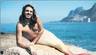  ?? DAVI MOREIRA / AGENCE FRANCE-PRESSE ?? Davi Moreira poses in his mermaid tail costume at Arpoador Rock on Ipanema Beach in Rio de Janeiro, Brazil.
