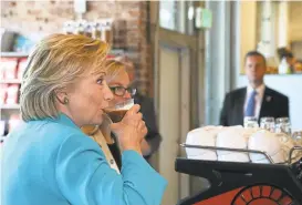  ?? JUSTIN SULLIVAN/GETTY IMAGES ?? Democratic presidenti­al candidate Hillary Clinton samples some java at Hub Coffee Roasters in a campaign swing through Reno on Thursday.
