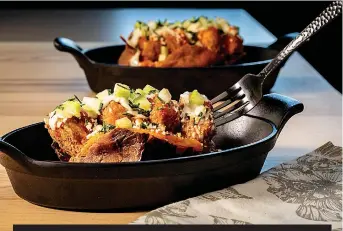  ?? Tribune News Service ?? ■ The classic idea of a loaded baked potato becomes dinner all by itself. Here sweet potatoes take the place of russets, and Buffalo chicken wings inspire the toppings. Think crispy chicken nuggets, blue cheese and hot sauce.