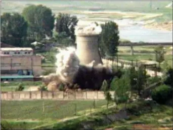  ?? AP PHOTO/APTN, FILE ?? In this June 27, 2008 file image from TV, the demolition of the 60-foot-tall cooling tower at its main reactor complex in Yongbyon North Korea. North Korea’s Foreign Ministry said Saturday May 12, 2018, it will hold a “ceremony” for the dismantlin­g of...