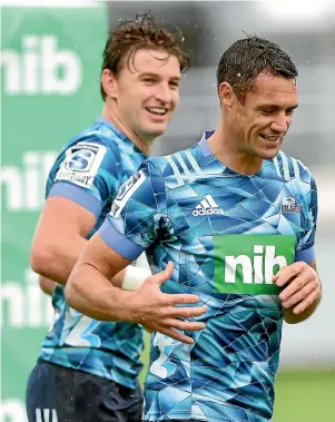  ??  ?? Current All Blacks superstar Beaduen Barrett, left, enjoys a joke with past master Dan Carter at Blues training in Auckland yesterday.