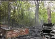  ?? BEN LAMBERT — THE REGISTER CITIZEN ?? A cottage at 334 Norwood Road in Winsted was destroyed by fire Monday evening. A victim in the fire was treated for burns and remains in Waterbury Hospital.