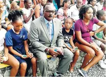  ?? GARETH DAVIS SR ?? Mayor of Port Antonio, Paul Thompson, sits with a group of children during the Christmas treat on Wednesday.