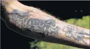  ??  ?? TATTOOS on Husidic’s arm depicts his family’s f light from Bosnia to escape the war there. “I don’t want to die here,” he remembers thinking.