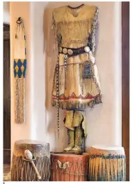  ??  ?? 6. A complete Kiowa woman’s outfit circa 1870s includes her high top moccasins, strike-a-light bag, awl case and belt with silver conchas. Also included is a rare Assiniboin­e tobacco bag and Pueblo drums.