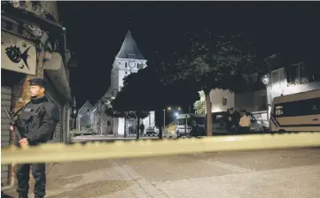  ?? — Reuters photo ?? French police stand guard near the church in Saint-Etienne-du-Rouvray, France, where French priest, Father Jacques Hamel, was killed with a knife and another hostage seriously wounded in an attack on the church that was carried out by assailants linked...