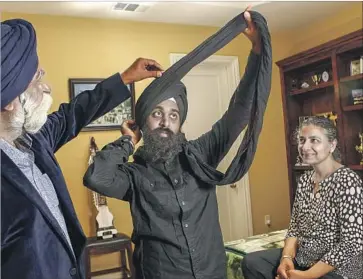  ?? Photograph­s by Irfan Khan Los Angeles Times ?? BALMEET SINGH, center, with his parents, Manbir Singh and Taran Kaur, was left shaken after a stranger threw a drink in his face and threatened to kill him, saying, “So, you’re going to blow up this country?”