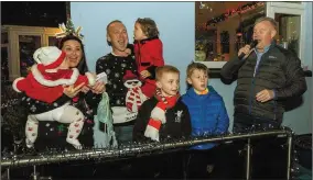  ??  ?? Virgin Media 3 News Anchor, Paul Byrne switches on the lights with members of the O’Callaghan Family at the annual Christmas Lights at Donal &amp; Peggy O’Callaghan, Codrum, Macroom. Photos: John Delea