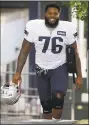  ?? Steven Senne / Associated Press ?? Patriots offensive tackle Isaiah Wynn steps on the field at the start of practice on Aug. 1 in Foxborough, Mass.