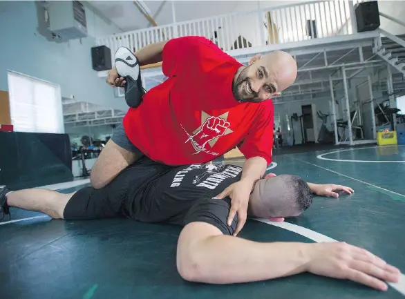  ?? JASON PAYNE ?? Arjan Bhullar, sparring with Brad Hildebrand­t, is now trying his hand at MMA after signing with the UFC, making him the first Indo-Canadian fighter on the circuit.