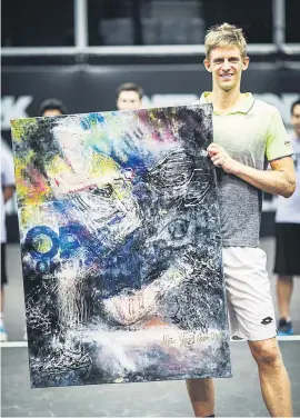  ?? Picture: ATP World Tour ?? PAINTING A WINNER. After winning the New York Open, Kevin Anderson poses with what must surely be the strangest trophy in tennis: an abstract painting of him.