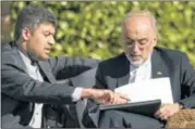  ?? BRENDAN SMIALOW SKI / REUTERS ?? The head of Iranian Atomic Energy Organizati­on Ali Akbar Salehi (right) looks over papers before meetings at the Beau Rivage Palace Hotel on Saturday in Lausanne.