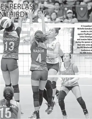  ??  ?? Creamline’s Michelle Gumabao sneaks in a hit against PayMaya’s Celine Domingo and Jasmine Nabor during the opener of their title series in the PVL Reinforced Conference at the MOA Arena.