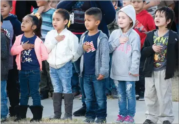  ?? RECORDER PHOTOS BY CHIEKO HARA ?? Students cite Pledge of Allegiance when the new flag is up Thursday during the annual Veterans Day observance ceremony at Alta Vista School in Portervill­e.