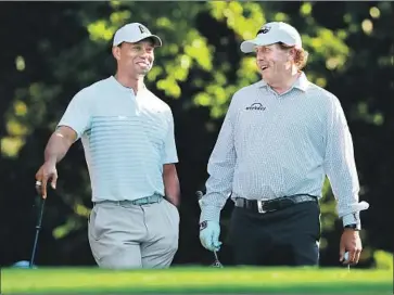  ?? Curtis Compton Atlanta Journal-Constituti­on ?? IN A SCENE that would have been unlikely a few years ago, Tiger Woods, left, and Phil Mickelson share a laugh while playing a practice round at the Masters in April. They have one win in five years between them.