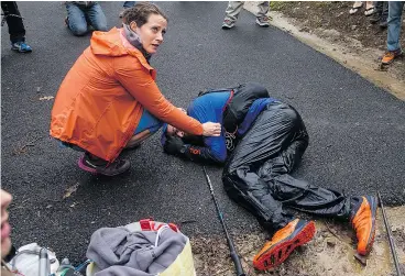  ?? PHOTOS: MICHAEL DOYLE ?? Runner Gary Robbins collapses Monday at the finish line of the 60-hour Barkley Marathon in Wartburg, Tenn. Robbins misread his map, veered off course, and ended up two miles short and six seconds over the time limit.