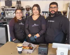  ?? ADOLPHE PIERRE-LOUIS/JOURNAL ?? From left, Sugar N Glitz baker Genesis Hernandez, 14, and her parents Norma and Al Hernandez behind the counter at Sueños Coffee Co.