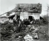  ?? (HMP) ?? ■ In this photo of the Advanced Dressing Station at Feuchy Chapel, Hardy can clearly be identified. He is standing in the centre background; his clerical collar can be clearly seen. Many of the bodies in the foreground are awaiting burial – and almost certainly lie today in the Tilloy British Cemetery in Tilloy-lèsMofflai­nes.