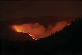  ?? The Associated Press ?? The Calf Canyon/Hermit Peak Fire burns south of Las Vegas, N.M., on Saturday.