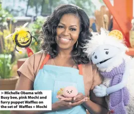  ??  ?? Michelle Obama with Busy bee, pink Mochi and furry puppet Waffles on the set of Waffles + Mochi