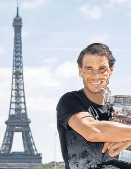  ??  ?? French Open winner Rafael Nadal with the trophy in front of the Eiffel Tower in Paris on Monday.