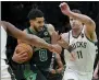  ?? STEVEN SENNE - THE ASSOCIATED PRESS ?? Boston Celtics forward Jayson Tatum (0) tries to drive past Milwaukee Bucks guard Jevon Carter, left, and center Brook Lopez (11) in the second half of Game 1 in the second round of the NBA Eastern Conference playoff series, Sunday, May 1, 2022, in Boston.