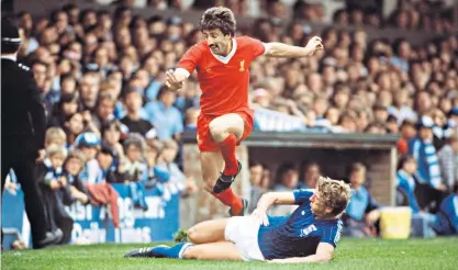  ?? ?? Johnson hurdling a challenge from Ipswich Town defender Terry Butcher and, right, lifting the European Cup in Paris, 1981: his cheerfulne­ss made him well-liked in the dressing room