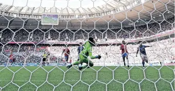  ?? | AFP ?? COSTA Rica’s Keysher Fuller scores the winning goal past Japan goalkeeper Shuichi Gonda at the Ahmad Bin Ali Stadium yesterday.