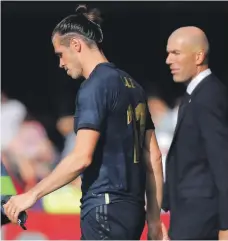  ?? EPA ?? Gareth Bale, left, exchanged a hand slap with Zinedine Zidane when the coach replaced him in the 75th minute in Vigo