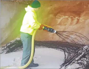  ?? BILL RETTEW JR. – DIGITAL FIRST MEDIA ?? A West Goshen Township employee sprays beet juice onto a pile of road salt.