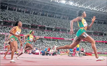  ??  ?? Elaine Thompson-herah, of Jamaica, on way to gold in women’s 200 metres at Tokyo Olympics