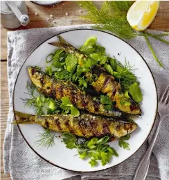  ??  ?? Serves 2 6 sardines, gutted 1 clove of garlic 2 tbsp cumin seeds 1 tsp turmeric 2 tbsp olive oil 1 lemon, plus wedges to serve sea salt and black pepper 6 spring onions 1 bunch of dill, thyme, flat-leaf parsley and mint