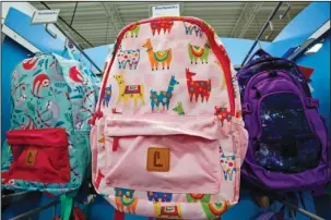  ?? The Associated Press ?? LLAMAS VS. UNICORNS: A display of back-to-school backpacks is shown July 18 in a store in Pittsburgh. Rainbow unicorns are seeing a bit of competitio­n. Llamas are in demand for decoration on backpacks and other school supplies this year.