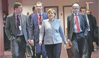  ?? — AFP ?? BRUSSELS: German Chancellor Angela Merkel arrives to address a press conference at the end of a special EU leaders’ meeting of the European Council to adopt the guidelines for the Brexit talks, in Brussels yesterday.