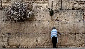  ?? AP/DUSAN VRANIC ?? An ultra-Orthodox Jew prays recently in Jerusalem at the Western Wall, one of the holiest landmarks in Judaism.