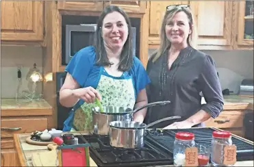  ?? Contribute­d ?? Kay Anderson (right) shares one of her favorite recipes with Loretta Self.