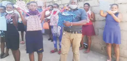  ??  ?? Mr Trymore Ndolo, founder of Pathways Women Empowermen­t and Girl Child Support Network Trust shows samples of reusable sanitary pads supreme kits with some of the beneficiar­y girls. There could be a hashtag on buying dignity kits for pupils from rural schools around the country to find sanitary wear to manage their menstrual health with dignity