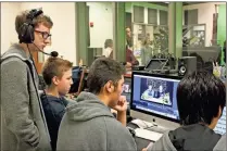  ??  ?? In the video production classes at Calhoun High School, students who aren’t comfortabl­e in front of the camera have the option to work behind the scenes, which is what freshman Carter Johnson and sophomore Noah Jones chose to do.