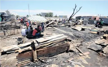  ?? PICTURE: AYANDA NDAMANE ?? BURNT OUT: About 145 people were left homeless at the weekend when a fire destroyed nearly 50 shacks and numerous other structures at Siyahlala informal settlement yesterday.